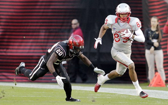 New Mexico wide receiver Quintell Solomon, right, runs upfield as San Diego State defensive back Nate Berhe tries to catch him in the first half on...