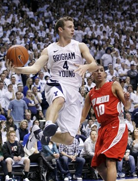 BYU guard Jackson Emery (4) looks for an open teammate as New Mexico guard Kendall Williams (10) defends during the first half of an NCAA college...