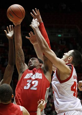 New Mexico forward Drew Gordon and Utah center Jason Washburn battle for a rebound.