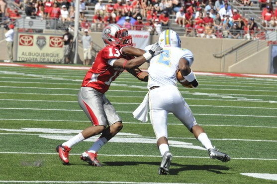 Senior defensive back DeShawn Mills wraps up Southern University's Lee Doss in the Lobos' contest vs. the Jaguars. Mills had two tackles and a sack at...