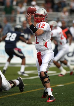 New Mexico quarterback B.R. Holbrook (12) throws against Nevada. (AP Photo/Cathleen Allison)