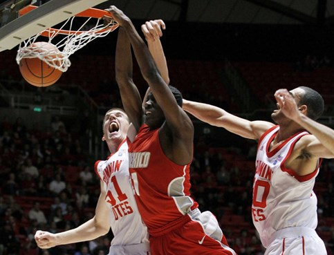 New Mexico guard Tony Snell dunks as Utah center David Foster and forward J.J. O'Brien defend.