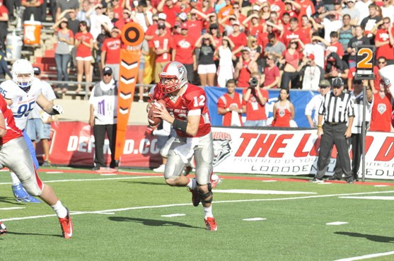 Quarterback B.R. Holbrook rolls out of the pocket, looking downfield for a target.