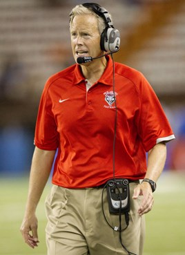 New Mexico head coach Bob Davie talks to his assistant coaches in the press box in the third quarter of an NCAA college football game against Hawaii...