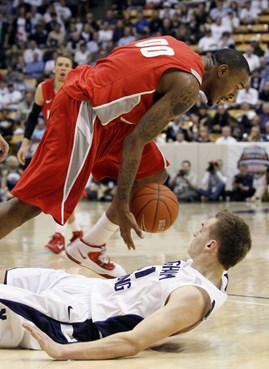 BYU guard Kyle Collinsworth, bottom, falls to the court as New Mexico forward A.J. Hardeman, top, steals the ball during the second half of an NCAA...