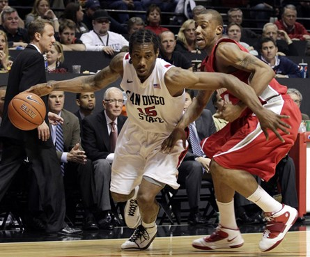 San Diego State's Kawhi Leonard, right, drives towards the basket as New Mexico's Chad Adams defends in the second half of an  NCAA college basketball...