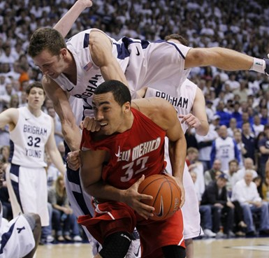 BYU guard Jackson Emery, top, falls on top of New Mexico forward Drew Gordon, bottom, during the second half of an NCAA college basketball game in...