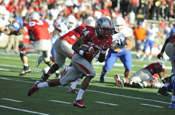 Wide receiver Carlos Wiggens runs down the field, seeking some open field.