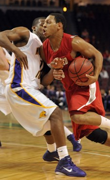 New Mexico's Dairese Gary drives into Northern Iowa's Kwazado Ahelegbe.