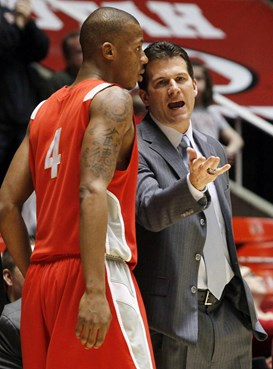 New Mexico coach Steve Alford talks with forward Chad Adams.