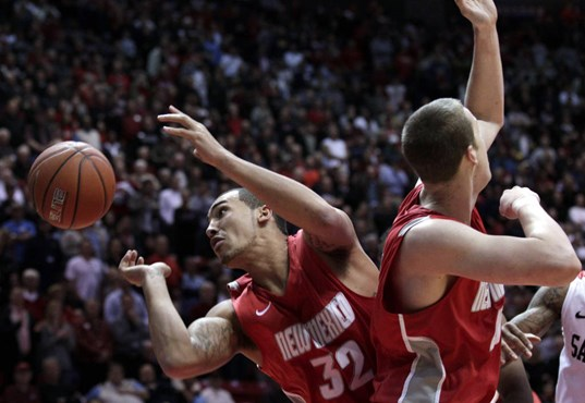 New Mexico's Billy White, left, watches a loose ball get away alongside teammate Mehdi Cheriet, right, during an NCAA college basketball game against...