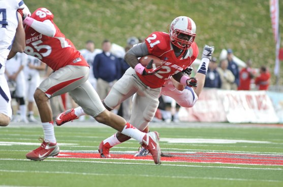 Crusoe Gongbay dodges Nevada as Quintell Solomon blocks.