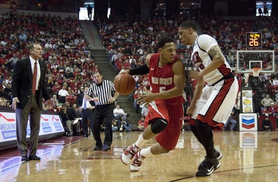 New Mexico's Dairese Gary drives against UNLV's Tre'Von Willis.