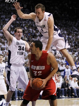 BYU guard Jackson Emery, top, falls on New Mexico forward Drew Gordon, bottom, as he and forward Noah Hartsock (34) defends during the second half of...