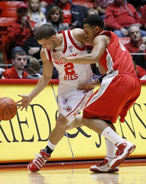 New Mexico guard Dairese Gary defends Utah guard Chris Kupets.