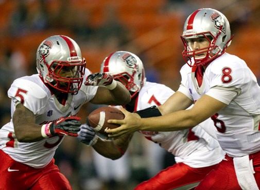 New Mexico running back Kasey Carrier (5) takes a hand off from his quarterback Cole Gautsche (8) in the first quarter of an NCAA college football...