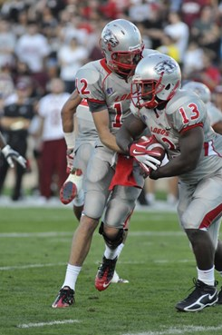 Quarterback B.R. Holbrook hands the ball off to James Wright