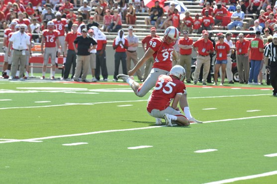 Junior Justus Adams lines up to knock the ball through the uprights with junior Ben Skaer holding. The Lobos scored six TDs in the first-half. (Dave...