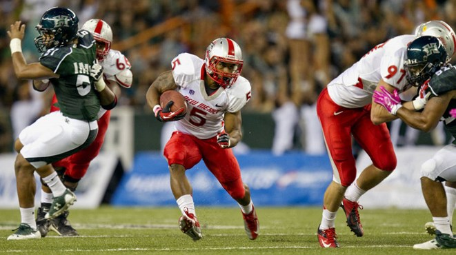 New Mexico running back Kasey Carrier (5) finds an opening in the Hawaii defensive line during the first quarter of an NCAA college football game,...