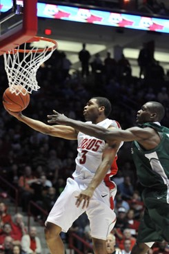 Sophomore Curtis Dennis drives to the hoop against the Greyhounds.